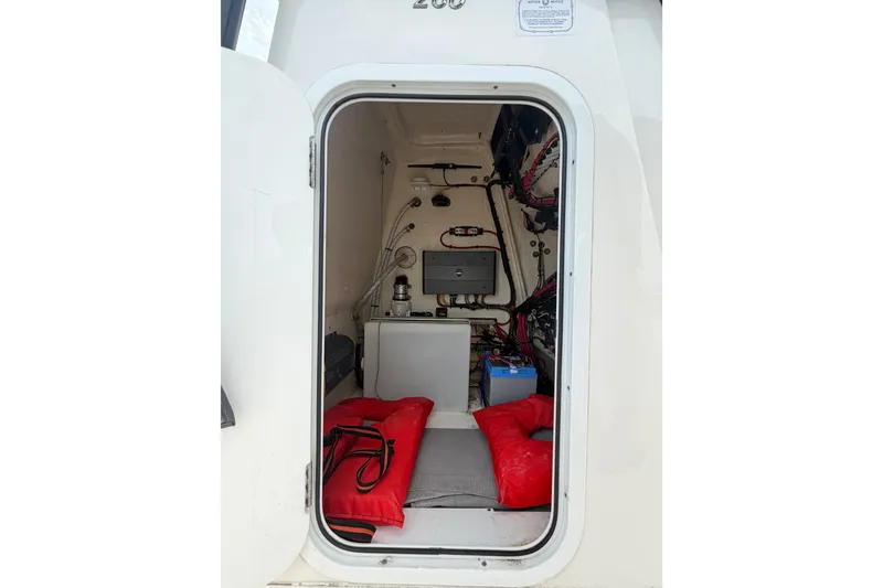 Slide: The Image of Interior view of a 2020 Sea Cat 260 boat cabin with equipment and red cushions. - 13