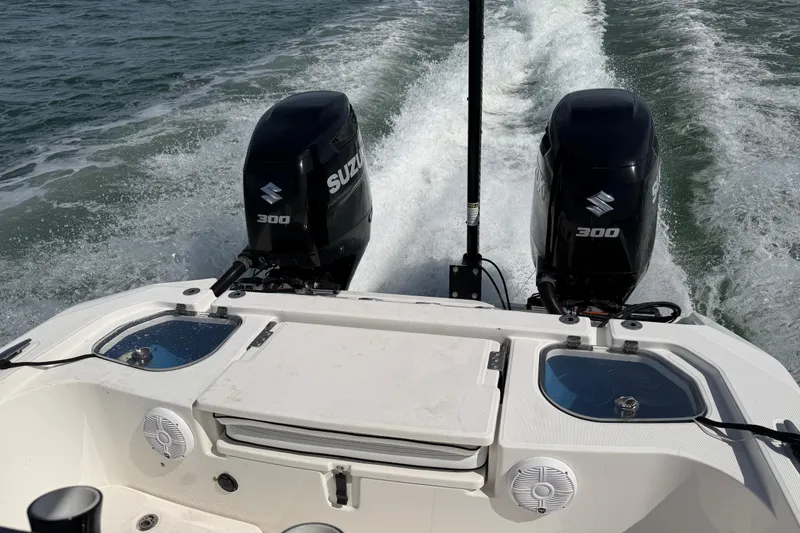 Slide: The Image of Twin Suzuki 300 engines on a 2020 Sea Cat 260 boat cruising through water. - 16