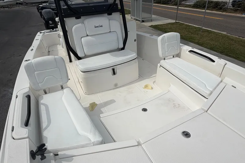 Slide: The Image of 2020 Sea Cat 260 boat interior with white seating and spacious deck layout. - 21