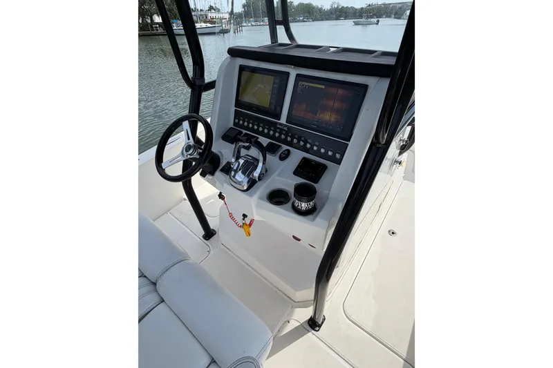 Slide: The Image of 2020 Sea Cat 260 boat helm with dual screens and steering wheel. - 6