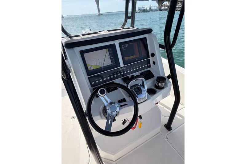 Slide: The Image of Helm of 2020 Sea Cat 260 boat with navigation screens and steering wheel. - 9