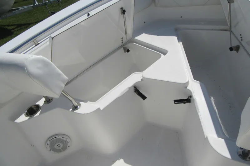 Slide: The Image of 2013 Sea Hunt Ultra 211 boat interior with seating and storage compartments. - 11
