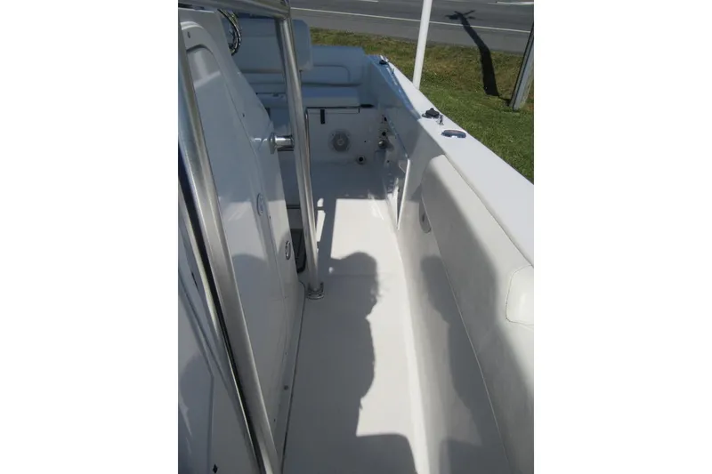 Slide: The Image of 2013 Sea Hunt Ultra 211 boat interior with white seating and stainless steel railings. - 13