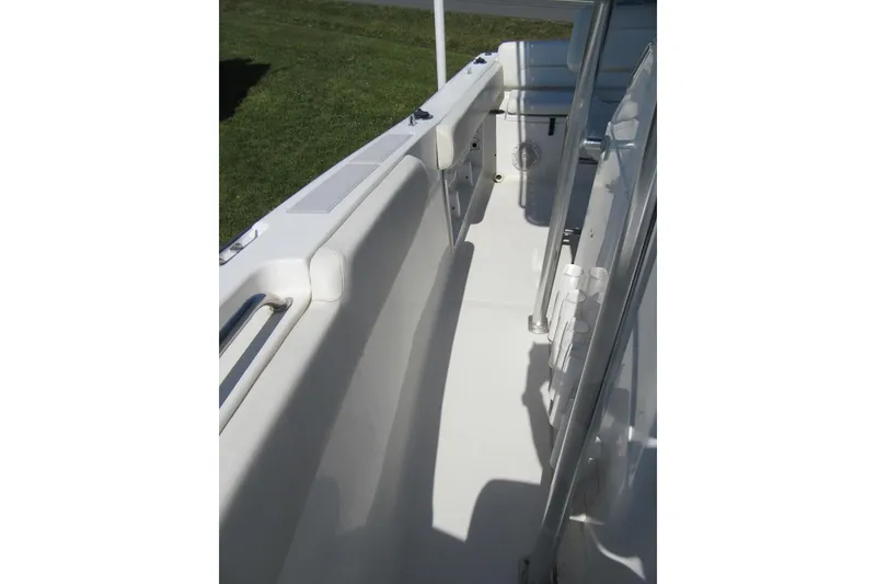 Slide: The Image of Interior view of a 2013 Sea Hunt Ultra 211 boat, showcasing seating and railing. - 14