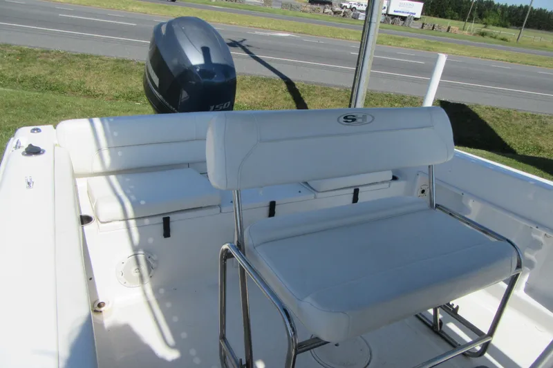 Slide: The Image of 2013 Sea Hunt Ultra 211 boat interior with seating and outboard motor. - 15