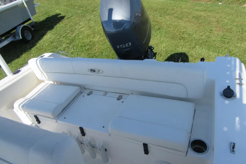 Slide: The Image of 2013 Sea Hunt Ultra 211 boat interior with seating and outboard motor. - 17