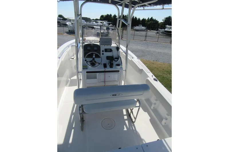 Slide: The Image of 2013 Sea Hunt Ultra 211 boat interior with steering console and seating. - 18