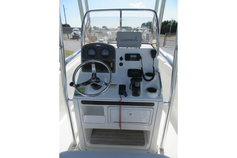Slide: The Image of 2013 Sea Hunt Ultra 211 boat console with Garmin navigation system and steering wheel. - 19