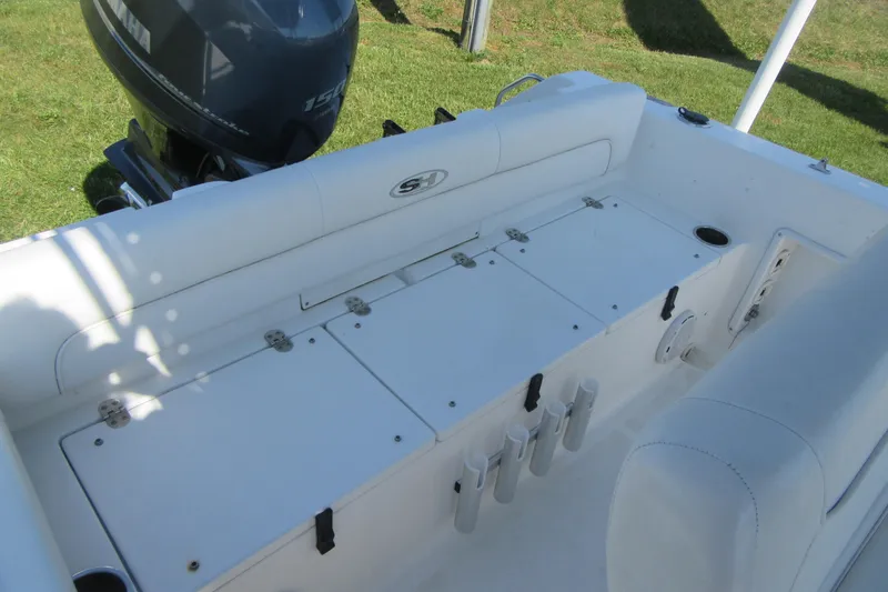 Slide: The Image of 2013 Sea Hunt Ultra 211 boat interior with Yamaha engine, featuring white seating and storage compartments. - 25