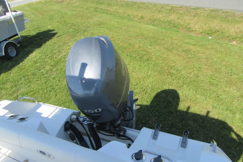 Slide: The Image of 2013 Sea Hunt Ultra 211 boat with Yamaha 150 outboard motor on grassy area. - 27