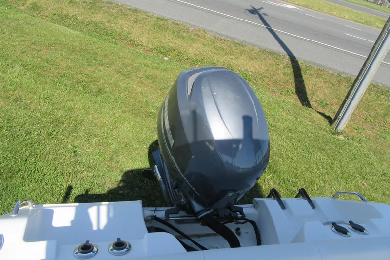 Slide: The Image of 2013 Sea Hunt Ultra 211 boat engine on grassy area near road. - 28