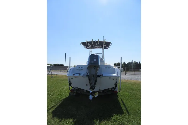 Slide: The Image of 2013 Sea Hunt Ultra 211 boat, rear view on grass, with outboard motor. - 3