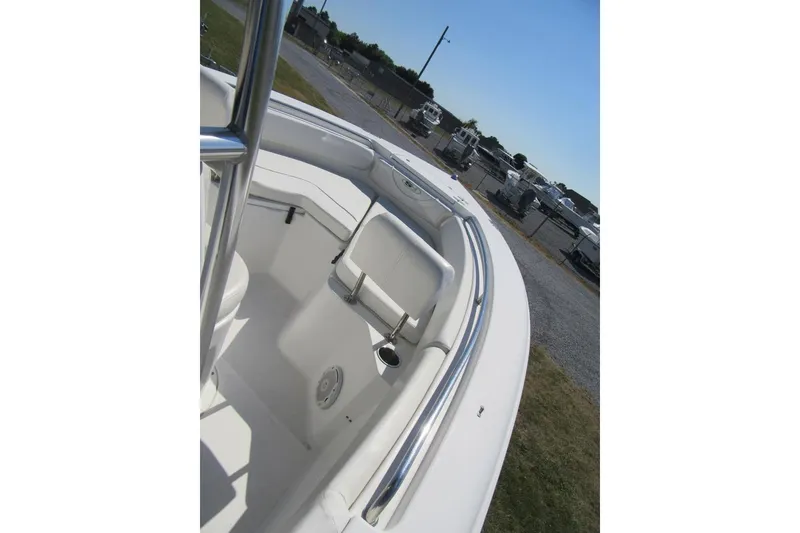 Slide: The Image of 2013 Sea Hunt Ultra 211 boat interior with white seating and stainless steel railing. - 8