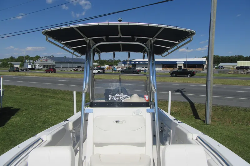 Slide: The Image of 2013 Sea Hunt Ultra 211 boat with T-top, parked near a road. - 9