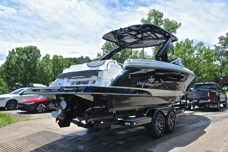 Slide: The Image of 2018 Chaparral 287 SSX boat on trailer, parked outdoors under a clear sky. - 15