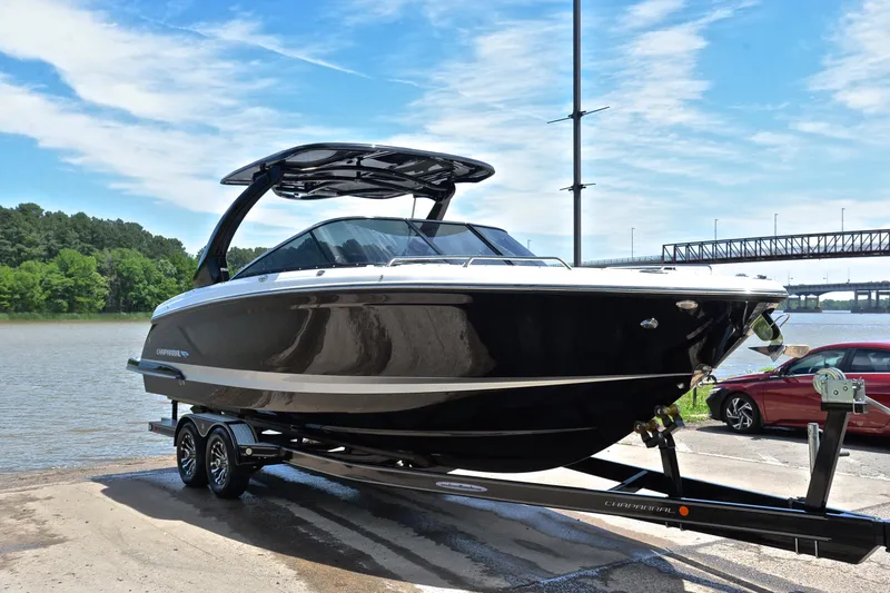 Slide: The Image of 2018 Chaparral 287 SSX boat on trailer by a scenic river. - 17