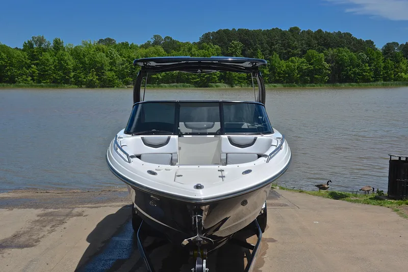 Slide: The Image of 2018 Chaparral 287 SSX boat on a ramp by a scenic lake. - 18