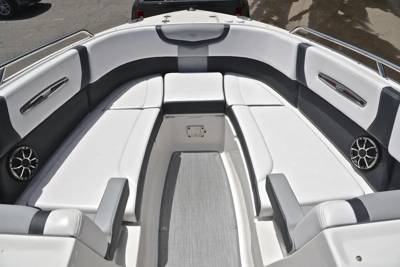 Slide: The Image of 2018 Chaparral 287 SSX boat interior with white and gray seating, featuring built-in speakers. - 22