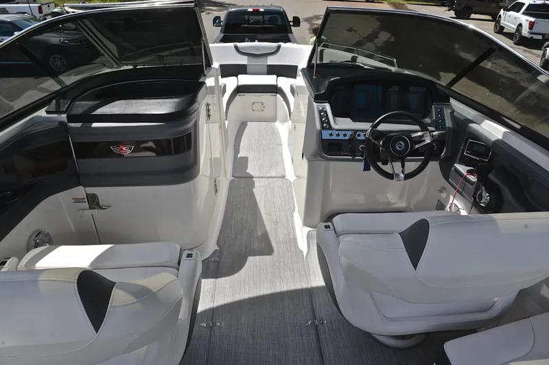 Slide: The Image of 2018 Chaparral 287 SSX boat interior with modern dashboard and seating. - 24