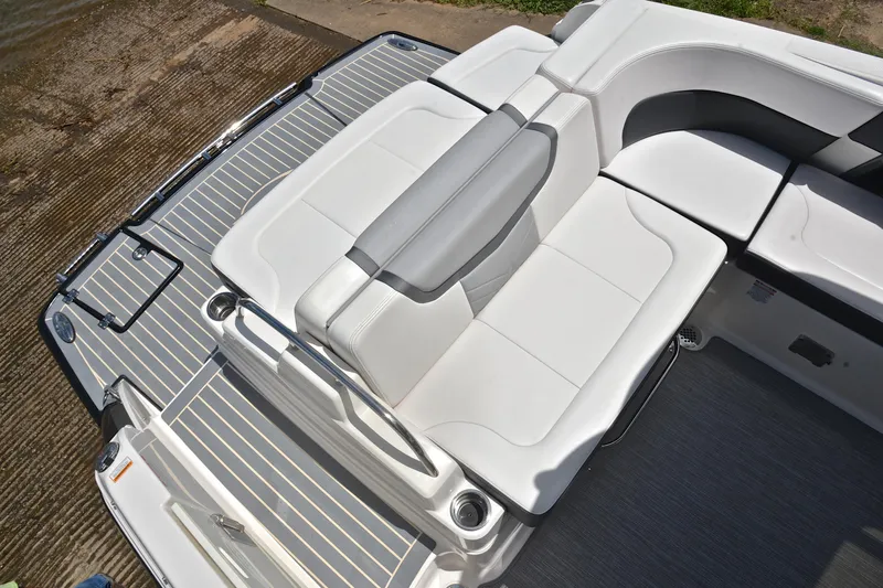 Slide: The Image of 2018 Chaparral 287 SSX boat with sleek white seating and spacious deck area. - 25