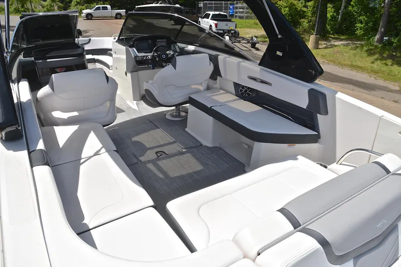Slide: The Image of 2018 Chaparral 287 SSX boat interior with luxurious white seating and modern dashboard. - 26