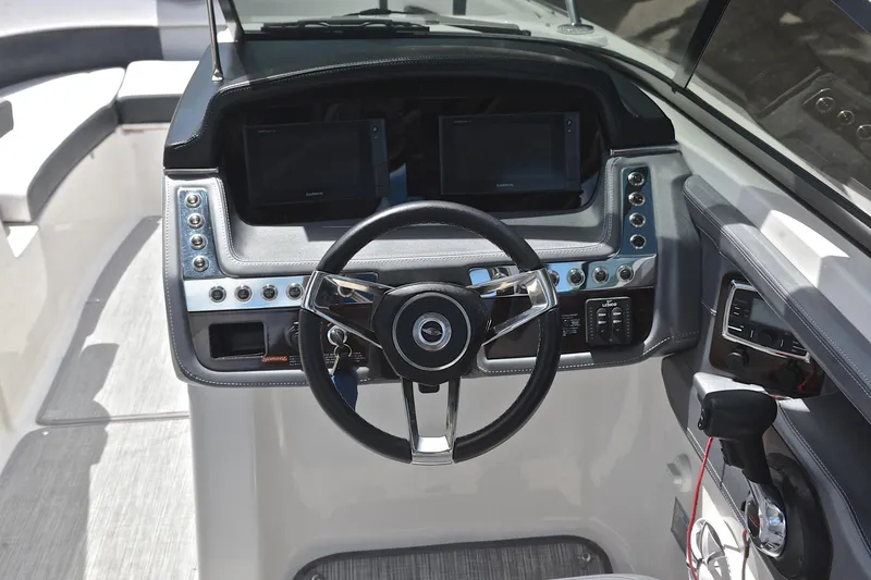 Slide: The Image of 2018 Chaparral 287 SSX boat dashboard with steering wheel and control panel. - 28