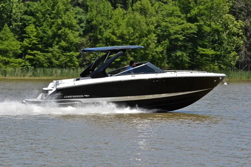 Slide: The Image of 2018 Chaparral 287 SSX speedboat cruising on a lake with lush green trees. - 3