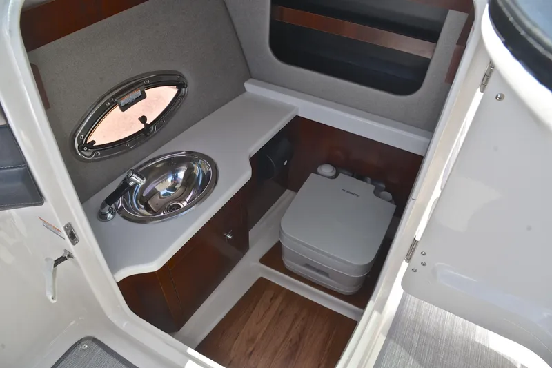 Slide: The Image of 2018 Chaparral 287 SSX boat interior with sink and portable toilet. - 30