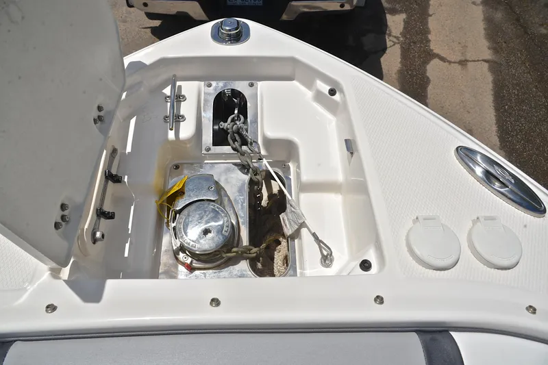 Slide: The Image of Anchor compartment of 2018 Chaparral 287 SSX boat, featuring chain and winch system. - 32