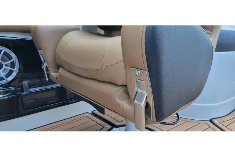 Slide: The Image of 2024 Crownline Eclipse E235 boat seat detail with speaker and teak flooring. - 14
