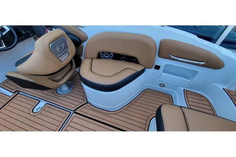 Slide: The Image of 2024 Crownline Eclipse E235 boat interior with tan seating and wood-style flooring. - 17