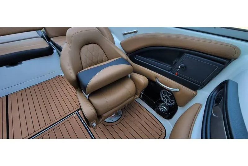 Slide: The Image of 2024 Crownline Eclipse E235 interior with tan leather seating and wood-style flooring. - 21