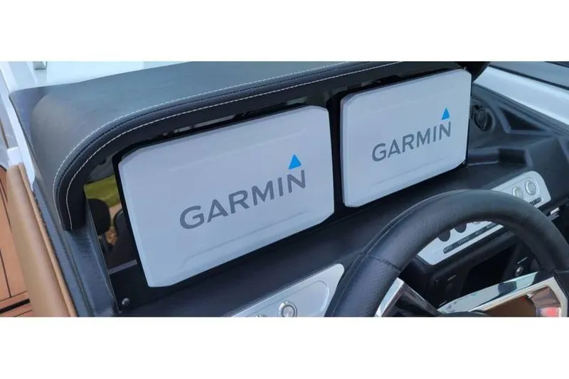 Slide: The Image of 2024 Crownline Eclipse E235 dashboard featuring dual Garmin displays. - 25