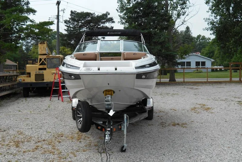 Slide: The Image of 2024 Crownline Eclipse E235 boat on trailer in outdoor setting. - 5