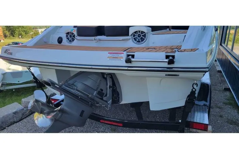 Slide: The Image of 2024 Crownline Eclipse E235 boat rear view with propeller and deck details. - 7