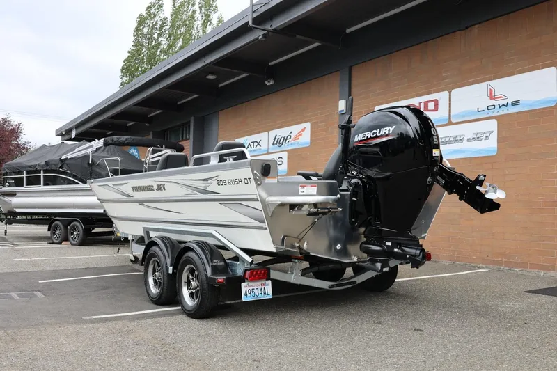 Slide: The Image of 2025 Thunder Jet 209 Rush OT boat with Mercury engine in parking lot. - 18