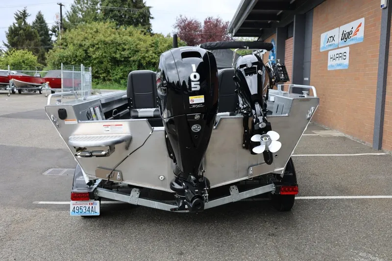 Slide: The Image of 2025 Thunder Jet 209 Rush OT boat with powerful outboard motor, parked outdoors. - 19