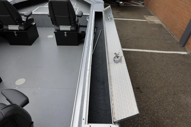 Slide: The Image of 2025 Thunder Jet 209 Rush OT boat interior with open storage compartment and seating. - 2