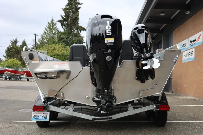 Slide: The Image of 2025 Thunder Jet 209 Rush OT boat with dual outboard motors, parked outdoors. - 20