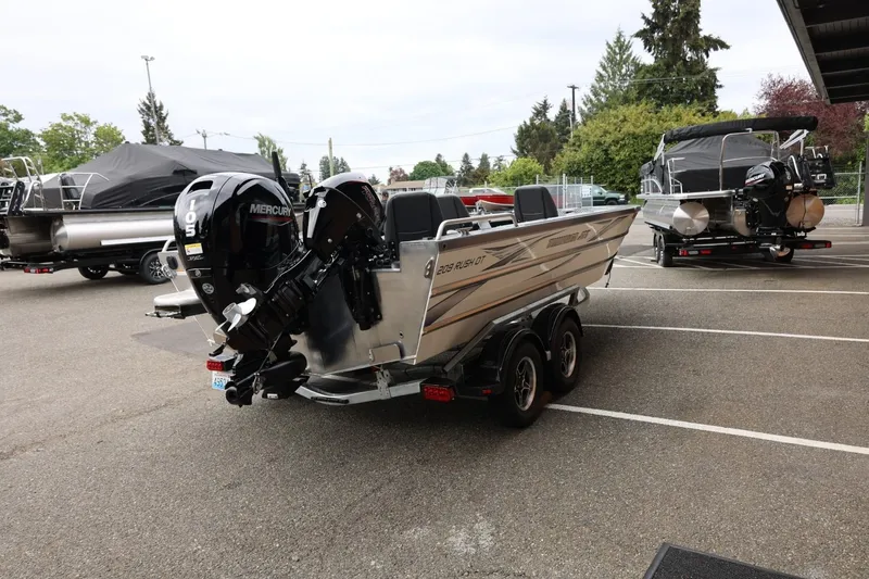 Slide: The Image of 2025 Thunder Jet 209 Rush OT boat with Mercury outboard motor in a parking lot. - 23