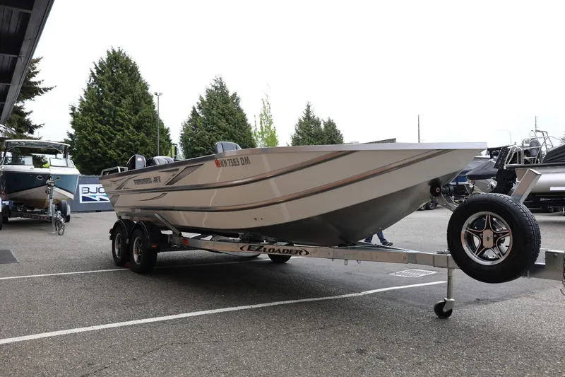 Slide: The Image of 2025 Thunder Jet 209 Rush OT boat on trailer, parked outdoors. - 25