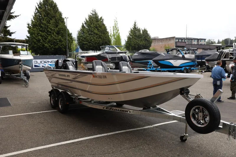 Slide: The Image of 2025 Thunder Jet 209 Rush OT boat on trailer at marina display. - 26