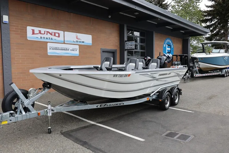 Slide: The Image of 2025 Thunder Jet 209 Rush OT boat on trailer outside dealership. - 29