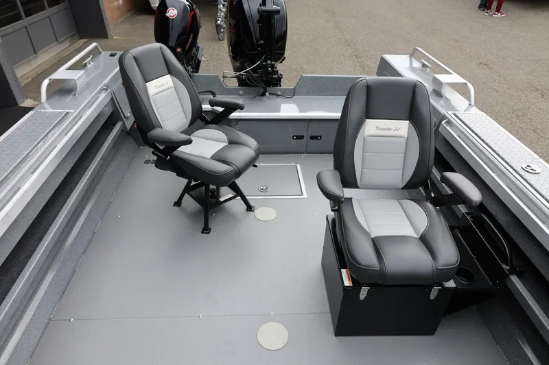 Slide: The Image of 2025 Thunder Jet 209 Rush OT boat interior with two cushioned seats and motor. - 3