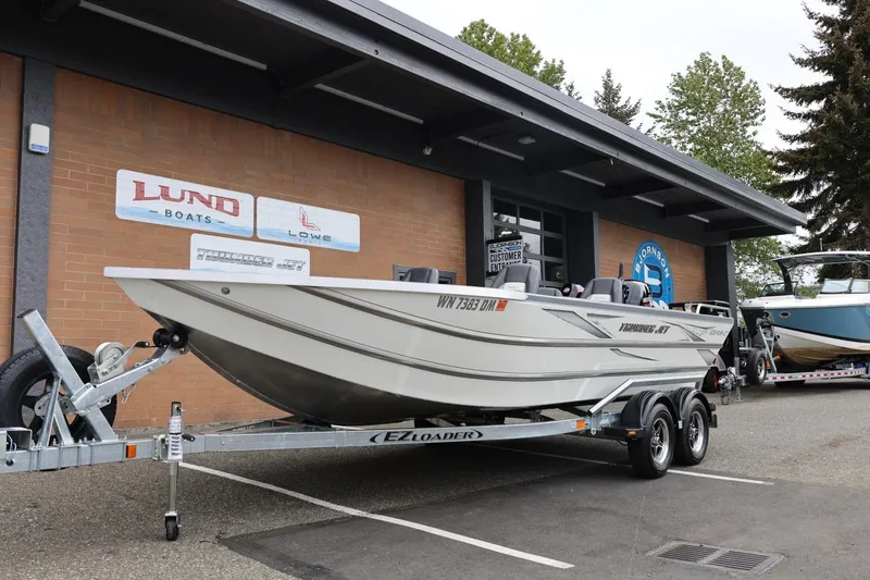 Slide: The Image of 2025 Thunder Jet 209 Rush OT boat on trailer outside dealership. - 30