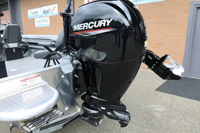 Slide: The Image of 2025 Thunder Jet 209 Rush OT with Mercury outboard motor, parked outdoors. - 31