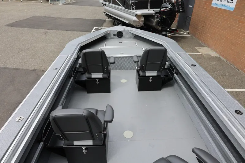 Slide: The Image of Interior view of 2025 Thunder Jet 209 Rush OT boat with four black seats. - 32