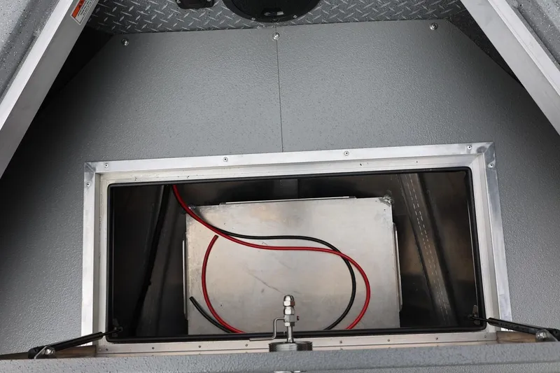 Slide: The Image of Storage compartment of 2025 Thunder Jet 209 Rush OT boat, featuring wiring and metal casing. - 35