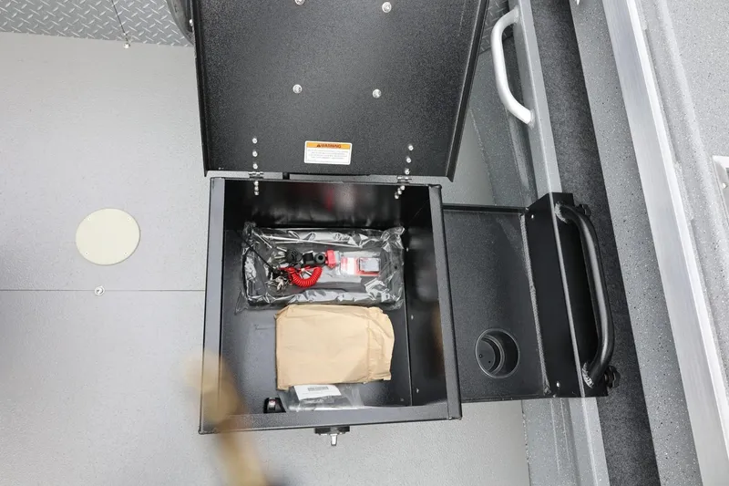 Slide: The Image of Storage compartment in 2025 Thunder Jet 209 Rush OT boat, containing safety equipment and accessories. - 38