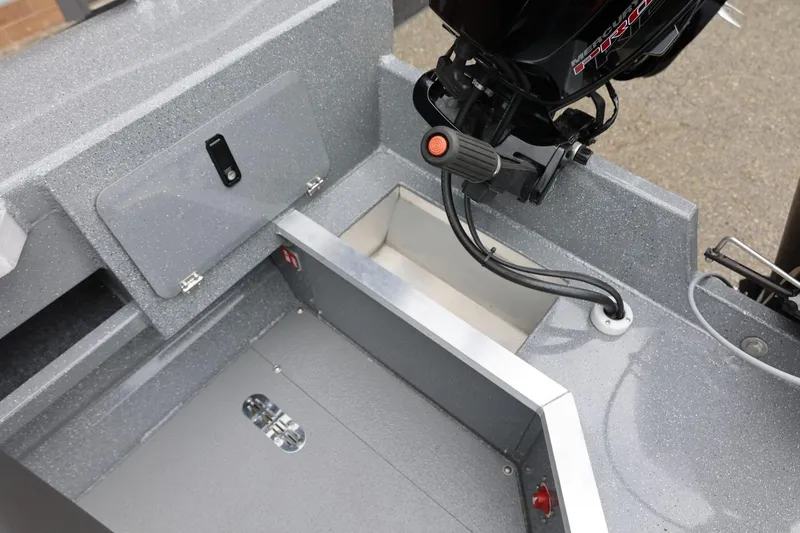 Slide: The Image of Interior view of 2025 Thunder Jet 209 Rush OT boat, showcasing storage and motor area. - 9